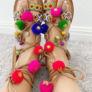 Pom Pom bohemian sandals by Francesca’s